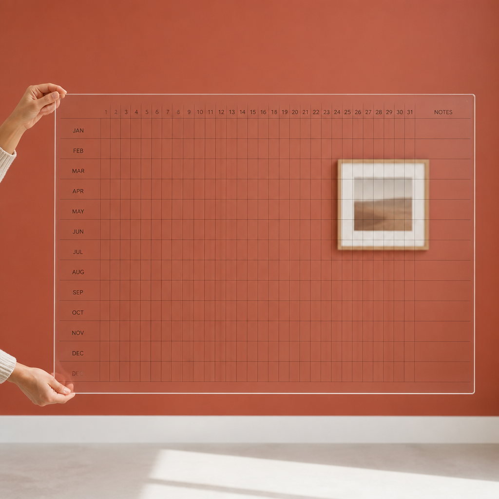 Transparent Perpetual Year Calendar on a wall, with the wall colour showing through the clear grid